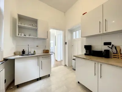 a kitchen with white cabinets and a counter top at Hypercentre 4 in Brussels