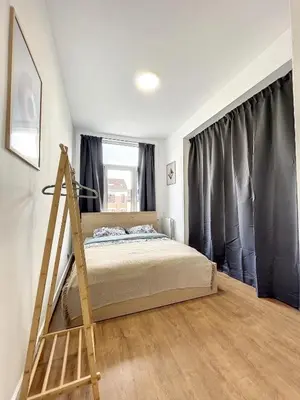 a bedroom with a bed and a wooden ladder at Hypercentre 4 in Brussels
