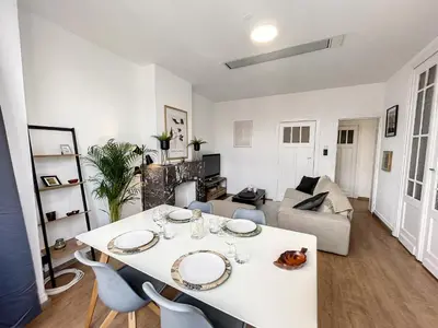 a living room with a white table and chairs at Hypercentre 4 in Brussels