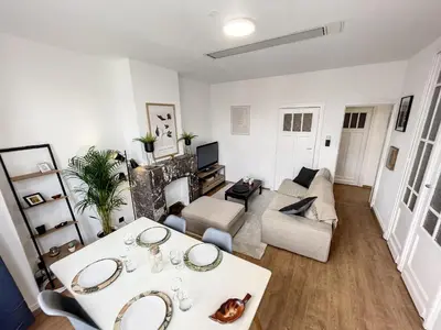 a living room with a table and a couch at Hypercentre 4 in Brussels