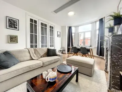 a living room with a couch and a table at Hypercentre 4 in Brussels