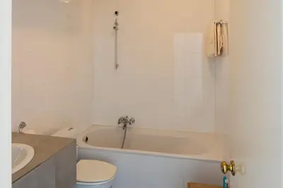 a bathroom with a tub and a toilet and a sink at De Witte Meren in Keerbergen