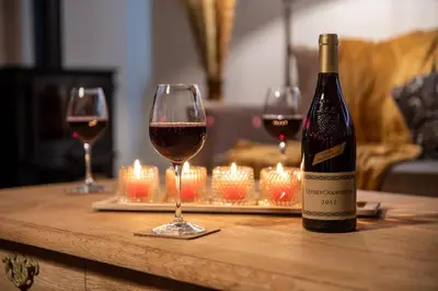 two glasses of wine on a table with candles at Anno 1673 in Evergem