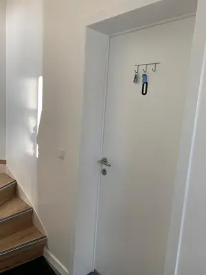 a white door in a room with stairs at Orange Dolce in Zaventem