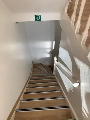 a staircase in a house with a sign on the wall at Orange Dolce in Zaventem