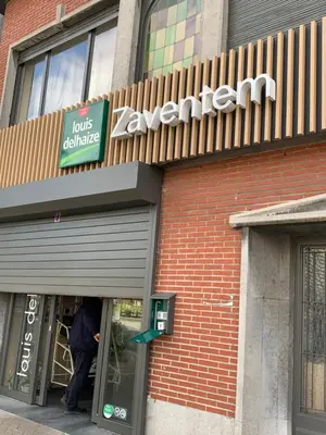a man standing in the door of a store at Orange Dolce in Zaventem