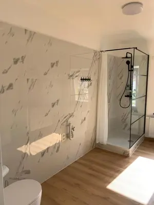 a bathroom with a shower and a toilet at Orange Dolce in Zaventem