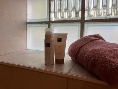 a bottle of lotion sitting on a window sill at Ons Hofke in Lubbeek