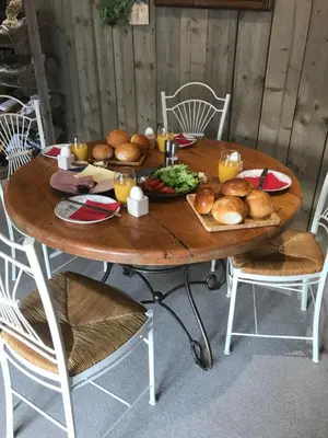 a wooden table with plates of food on it at Ons Hofke in Lubbeek