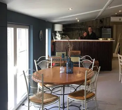 a dining room with a wooden table and chairs at Ons Hofke in Lubbeek