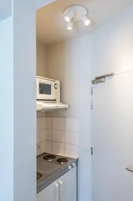 a kitchen with a microwave and a stove at Japie rooms - in the heart of Antwerp in Antwerp