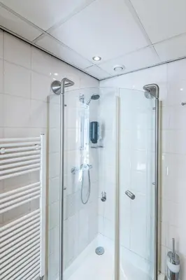 a bathroom with a shower with a glass door at Japie rooms - in the heart of Antwerp in Antwerp
