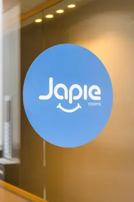 a blue sign on the door of a jape logo at Japie rooms - in the heart of Antwerp in Antwerp