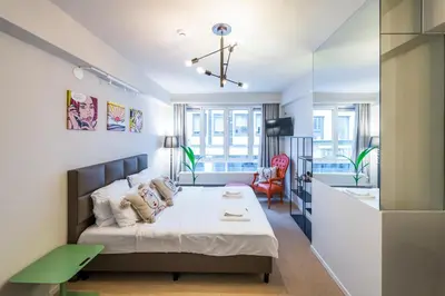 a small bedroom with a bed and a desk at Japie rooms - in the heart of Antwerp in Antwerp