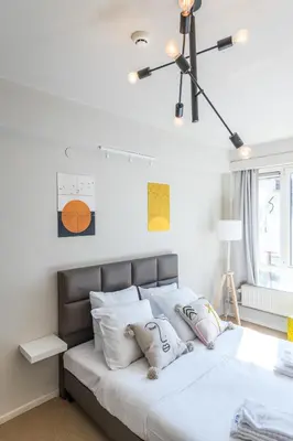 a bedroom with a large white bed with white pillows at Japie rooms - in the heart of Antwerp in Antwerp
