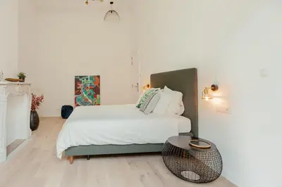 a bedroom with a bed and a table at RODELIJV in Ghent