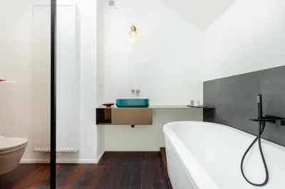 a bathroom with a tub and a toilet and a sink at RODELIJV in Ghent