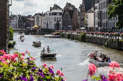 a group of people in boats on a river at RODELIJV in Ghent