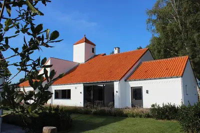 a white building with an orange roof at Landhuys Odette in Retie