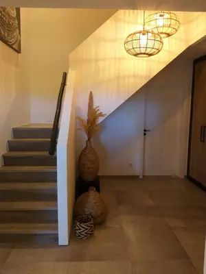 a hallway with a staircase with two baskets at Landhuys Odette in Retie