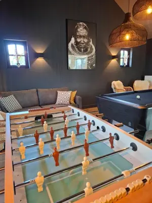 a living room with a large foosball table at Landhuys Odette in Retie