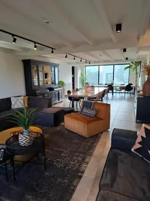 a large living room with couches and a table at Landhuys Odette in Retie