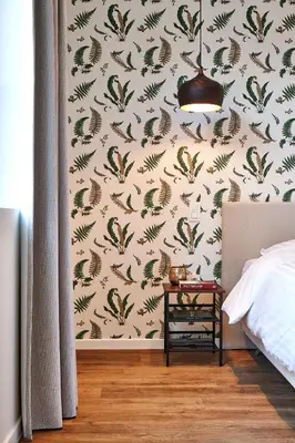 a bedroom with a wall covered in bird wallpaper at Kamerrijk in Pepingen