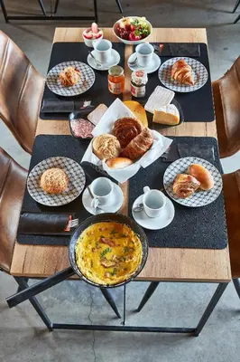 a table topped with plates of food and pastries at Kamerrijk in Pepingen