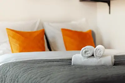 a bed with towels and two donuts on top of it at Luxury Suites South by Rikas Hotels in Antwerp