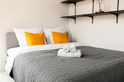a bedroom with a bed with towels and pillows at Luxury Suites South by Rikas Hotels in Antwerp