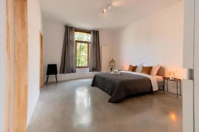 a bedroom with a large bed and a window at Luxury Suites South by Rikas Hotels in Antwerp