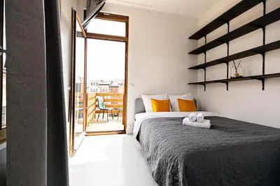 a bedroom with a bed and a sliding glass door at Luxury Suites South by Rikas Hotels in Antwerp