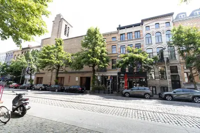 a scooter parked on a street in front of buildings at Luxury Suites South by Rikas Hotels in Antwerp