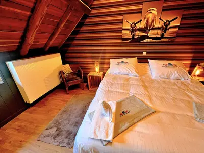a bedroom with a large bed in a room at Burgemeestershof in Wetteren