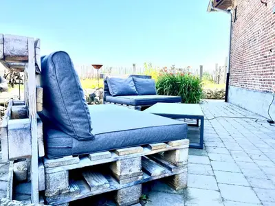 a couch sitting on a pallet on a patio at Burgemeestershof in Wetteren