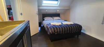 a bedroom with a bed with two towels on it at Penthouse 40 m2 in Zemst