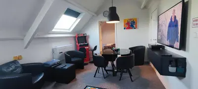 a room with a living room with a table and chairs at Penthouse 40 m2 in Zemst