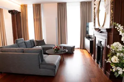 a living room with a couch and a tv at Botanique Suites AirBnB, Antwerp in Antwerp