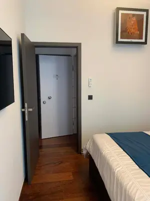 a bedroom with a door leading to a room with a bed at Botanique Suites AirBnB, Antwerp in Antwerp