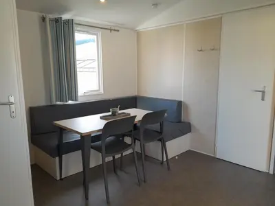 a room with a table and chairs and a window at Vakantiepark Breebos in Rijkevorsel
