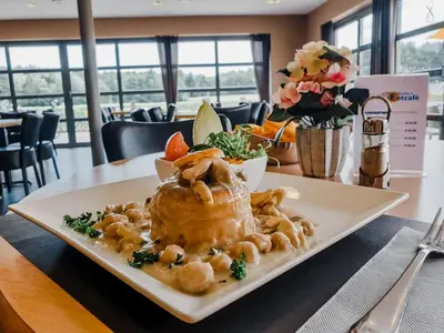 a plate of food sitting on a table at Vakantiepark Breebos in Rijkevorsel