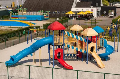 a playground with a slide in a park at Vakantiepark Breebos in Rijkevorsel