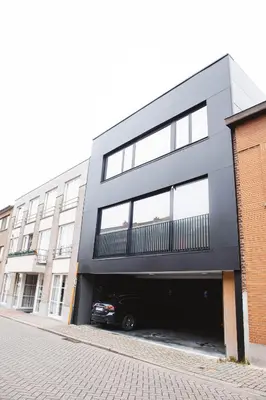 a black building with a car parked in the garage at K&Y suite 1 Brussels airport 500m! in Zaventem