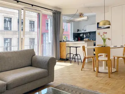 a living room with a couch and a table at Trendy & sunny apartment in Ghent in Ghent
