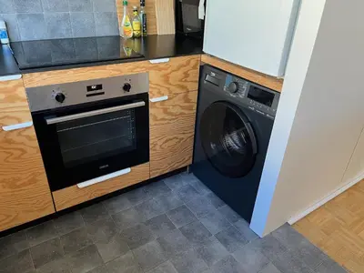 a kitchen with a dishwasher and a washing machine at Trendy & sunny apartment in Ghent in Ghent