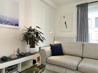 a living room with a couch and a table at Trendy & sunny apartment in Ghent in Ghent