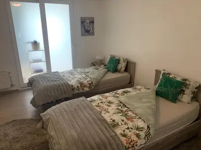 a room with two beds and a couch at Comme à la Maison in Brussels