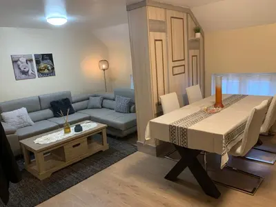 a living room with a table and a couch at Comme à la Maison in Brussels