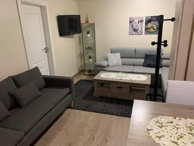 a living room with a couch and a coffee table at Comme à la Maison in Brussels