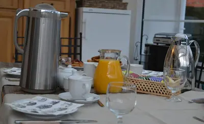 a kitchen counter with a coffee maker and glasses on it at B&B Den Boomgaard Moorsel in Moorsel